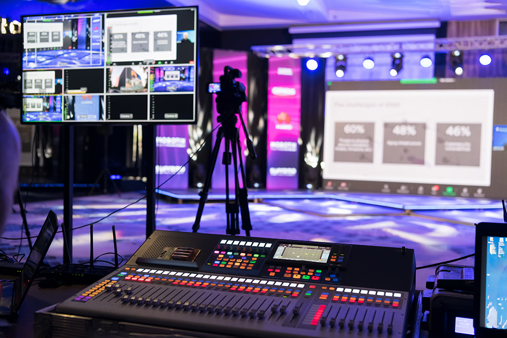 sound and recording equipment in the foreground with a studio space in the background